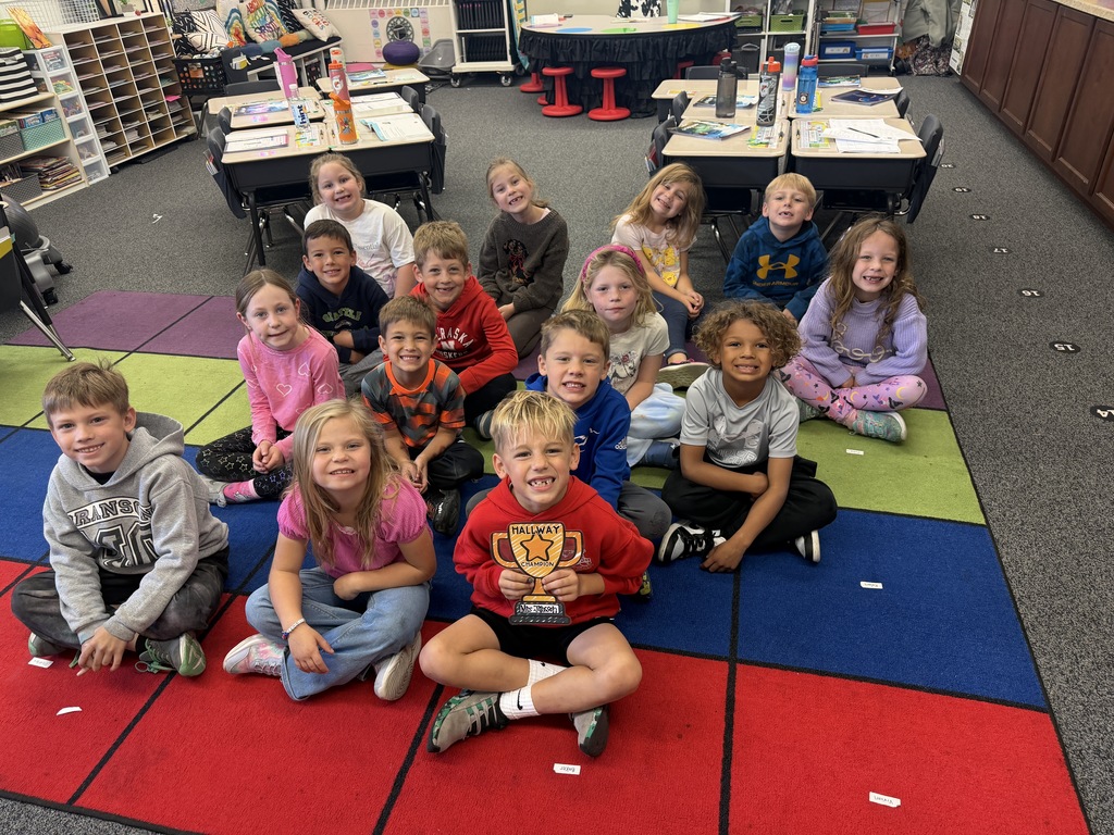 1st grade class sitting on carpet won hallway champions