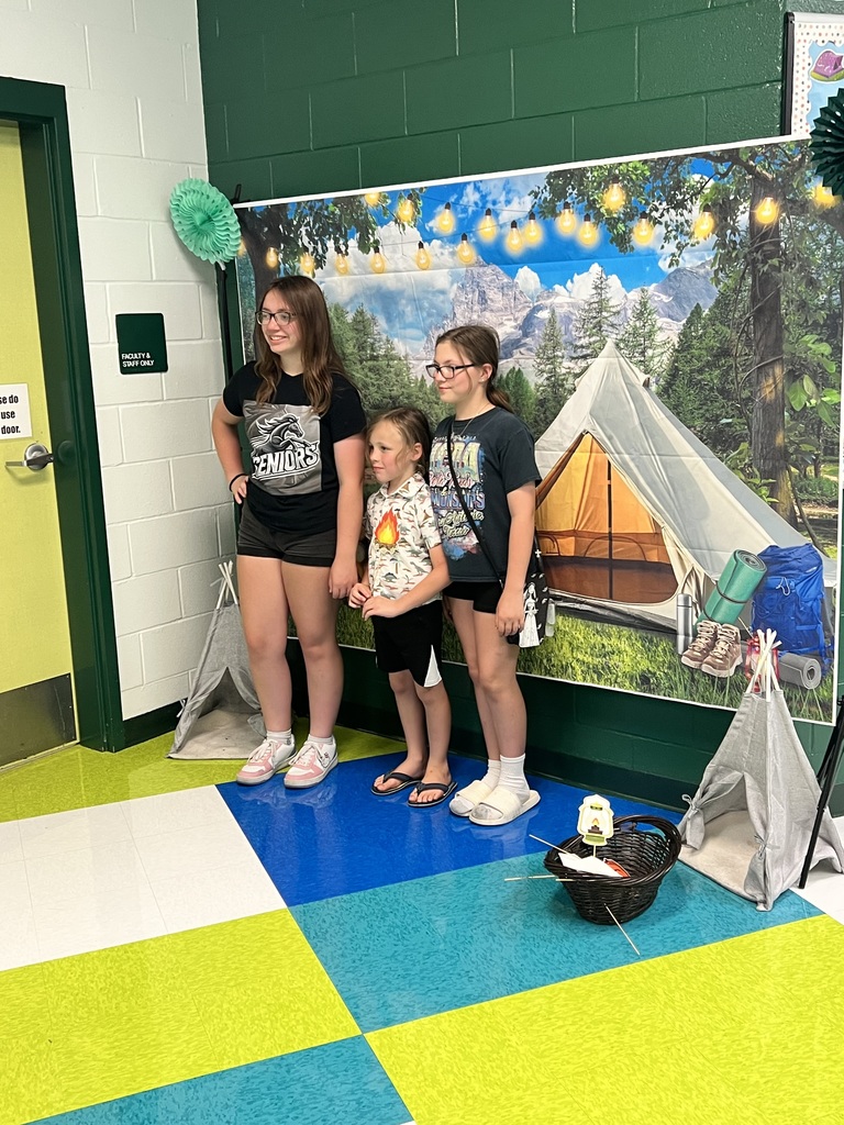 Taking picture in front of camping backdrop at Petty Meet the Teacher