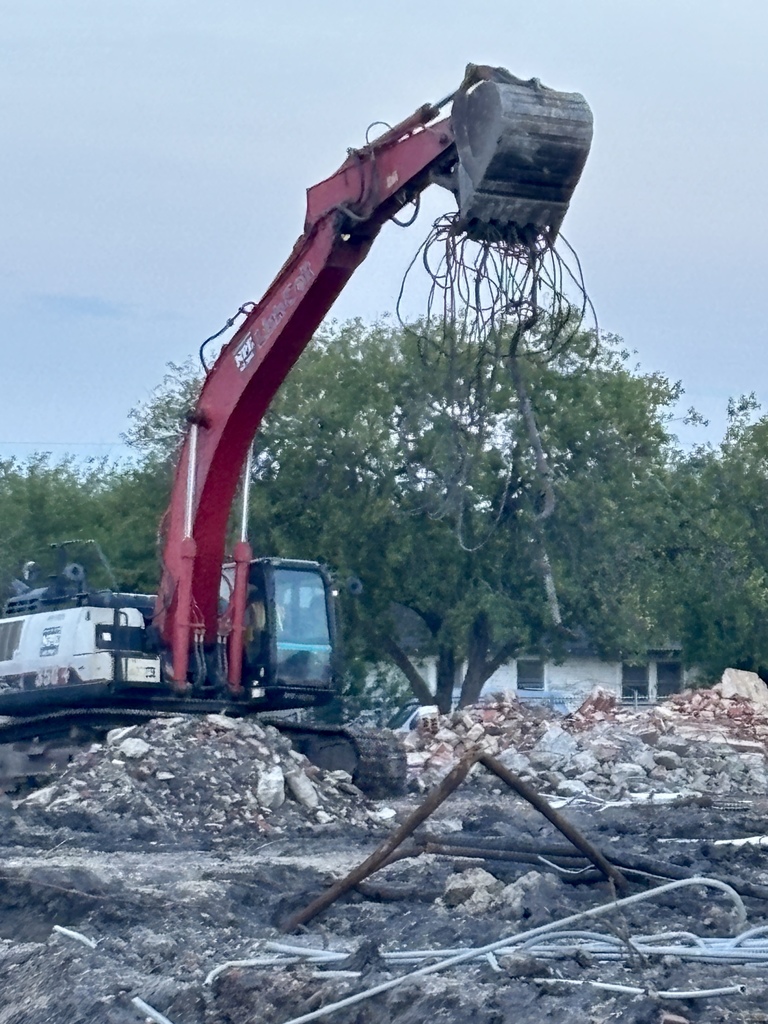 Digger removing debris