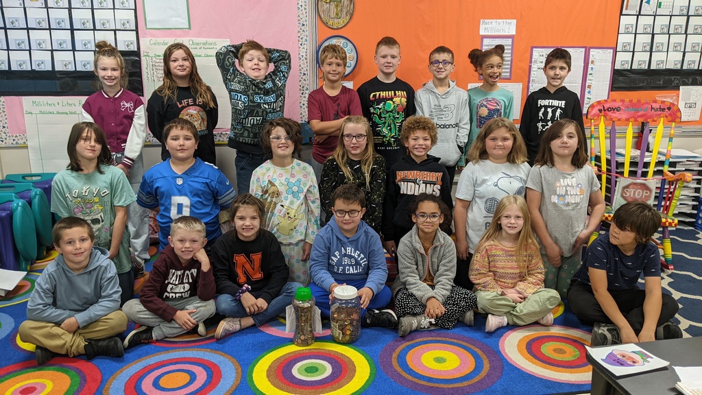 3rd grade boys and girls with 2 full containers of money.