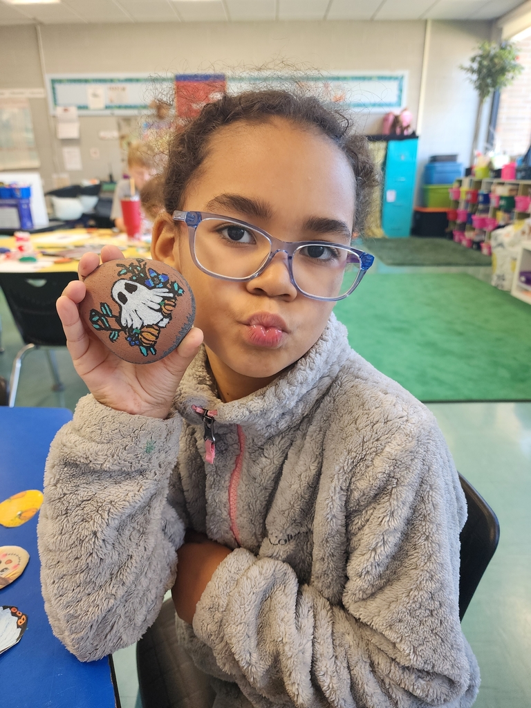 girl holding a rock painting