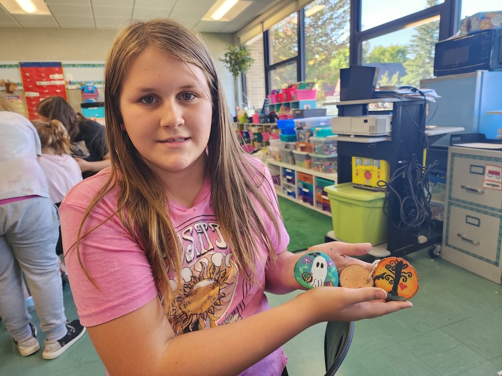 Girl holding rock painting