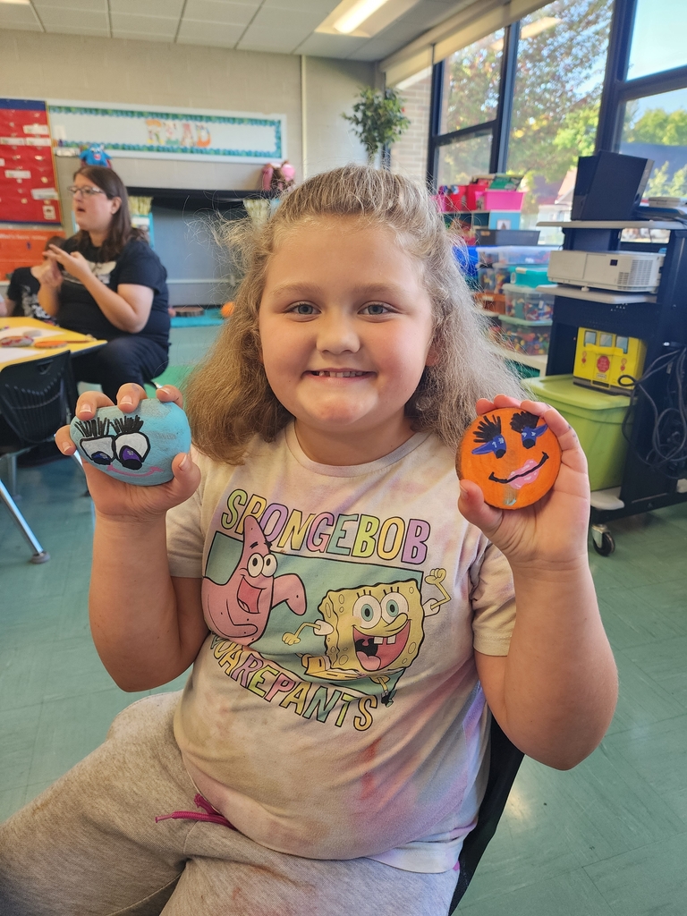 Girl holding rock paintings