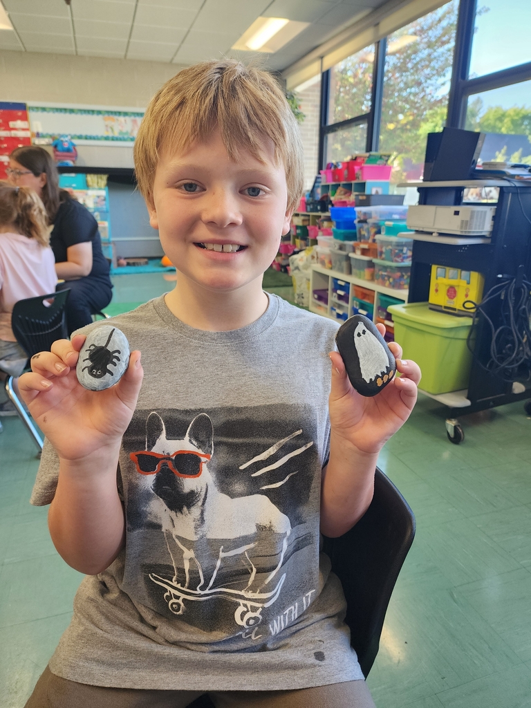Boy holding rock painting 