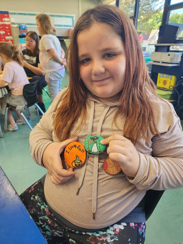 Girl holding rock painting 