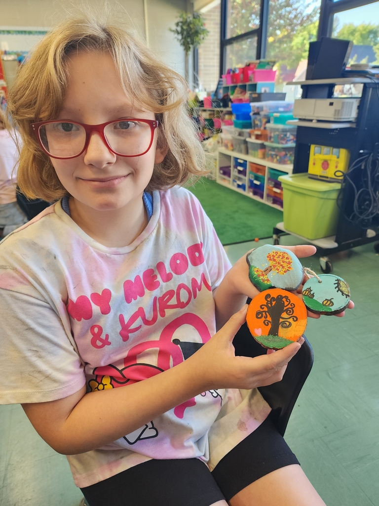 Girl holding rock painting 
