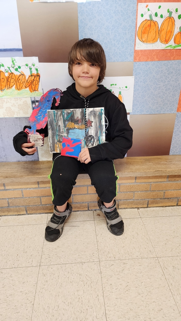 Boy holding paintings 