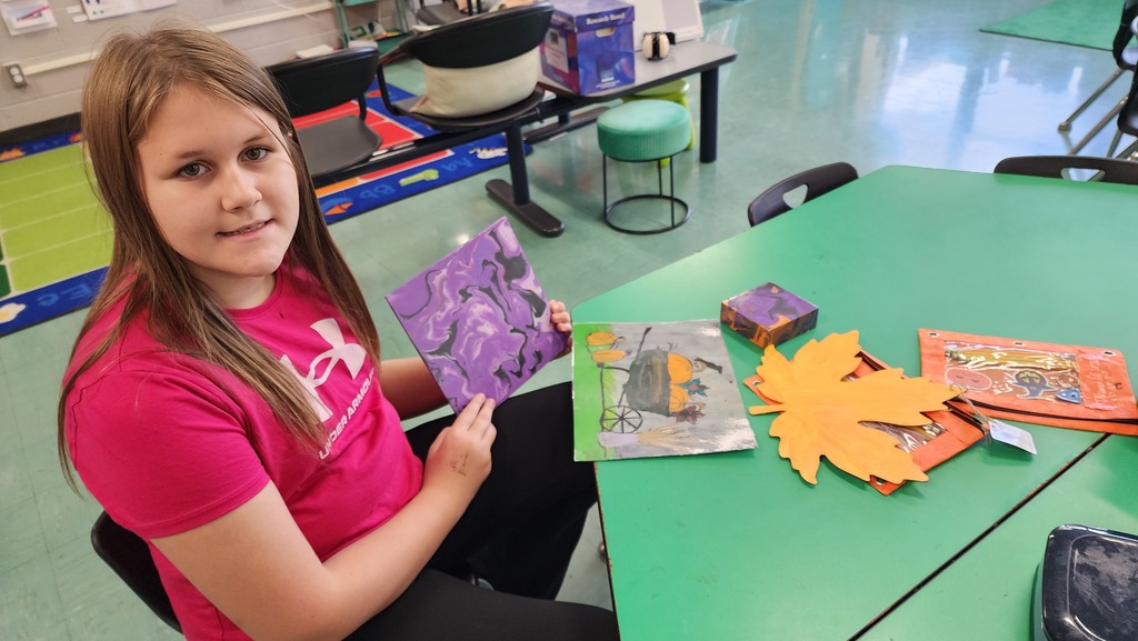 Girl holding paintings 