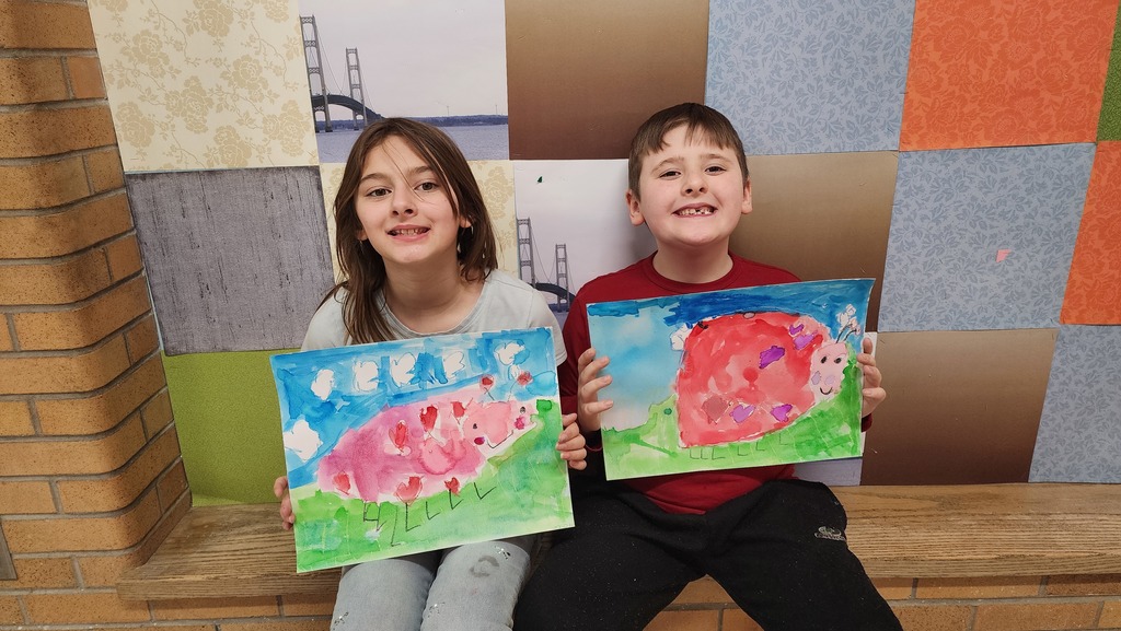 Students holding paintings