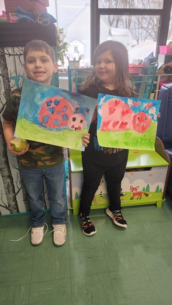 Students holding paintings 