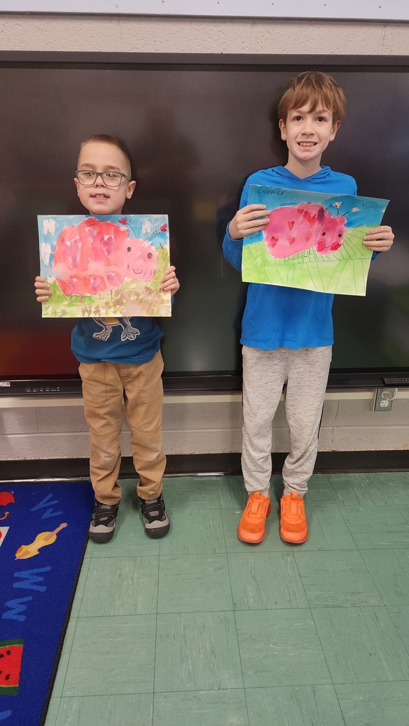 Students holding paintings 