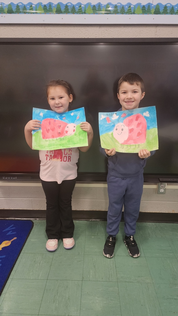 Students holding paintings 