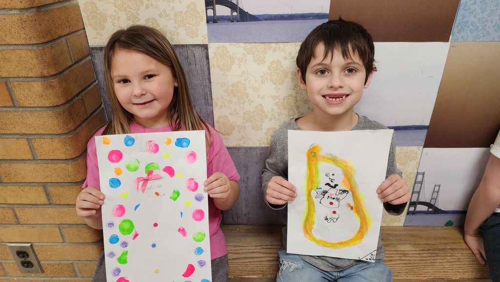Students holding paintings 
