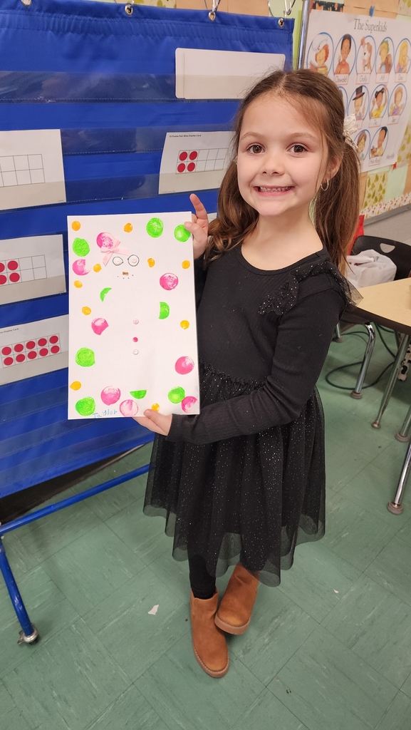 Student holding painting 