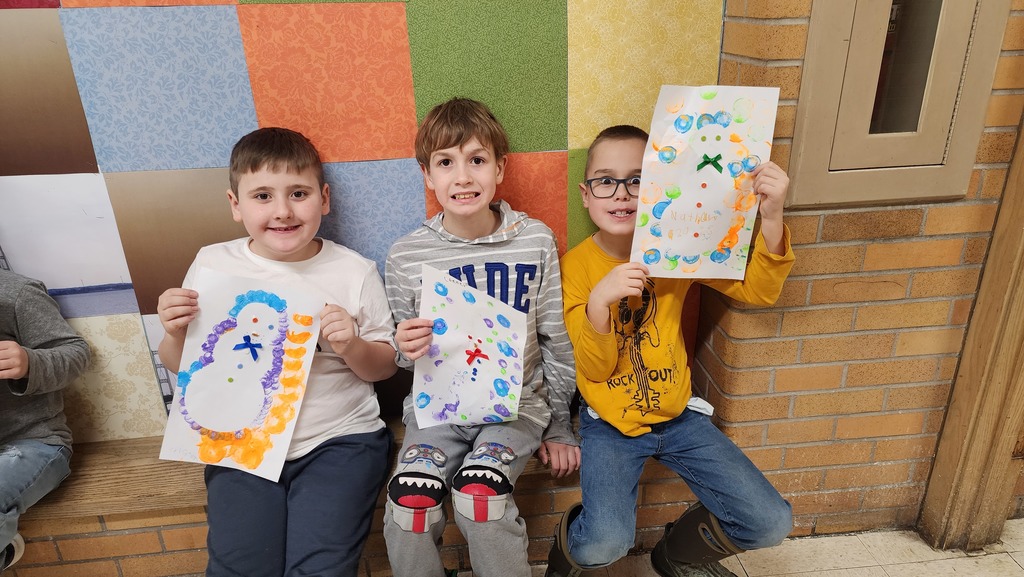 Students holding paintings 