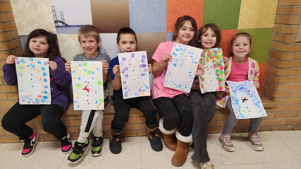 Students holding paintings 
