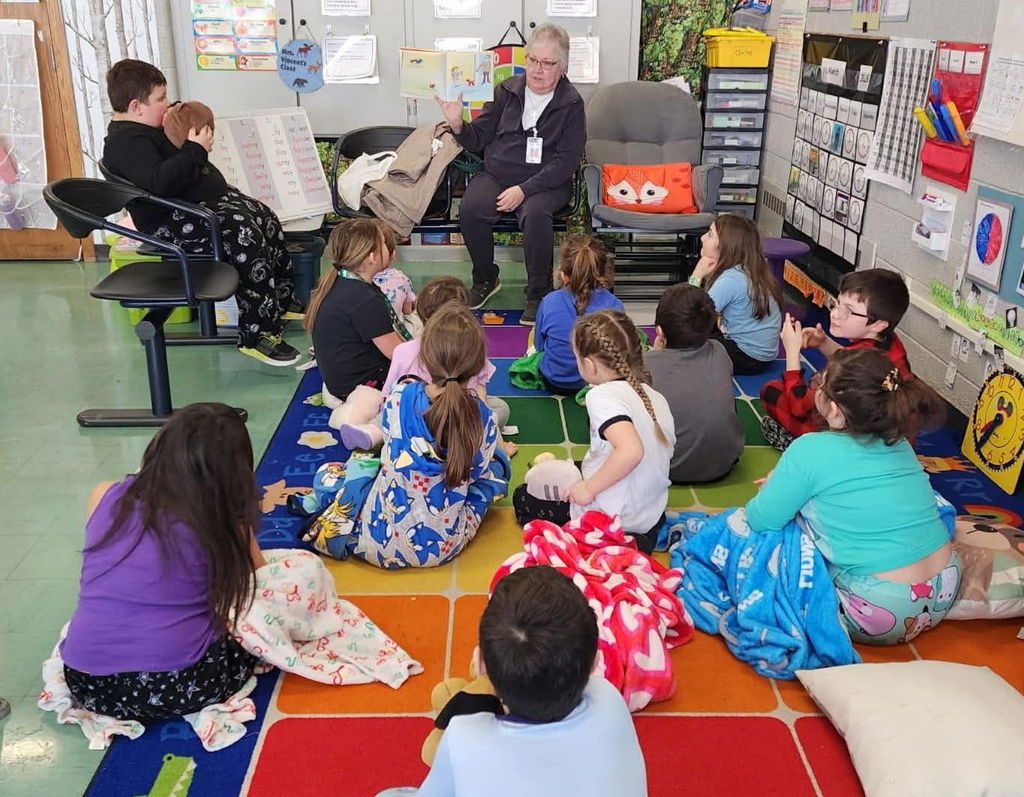 Retired teacher, Mrs. Dean is a guest reader in the first grade.