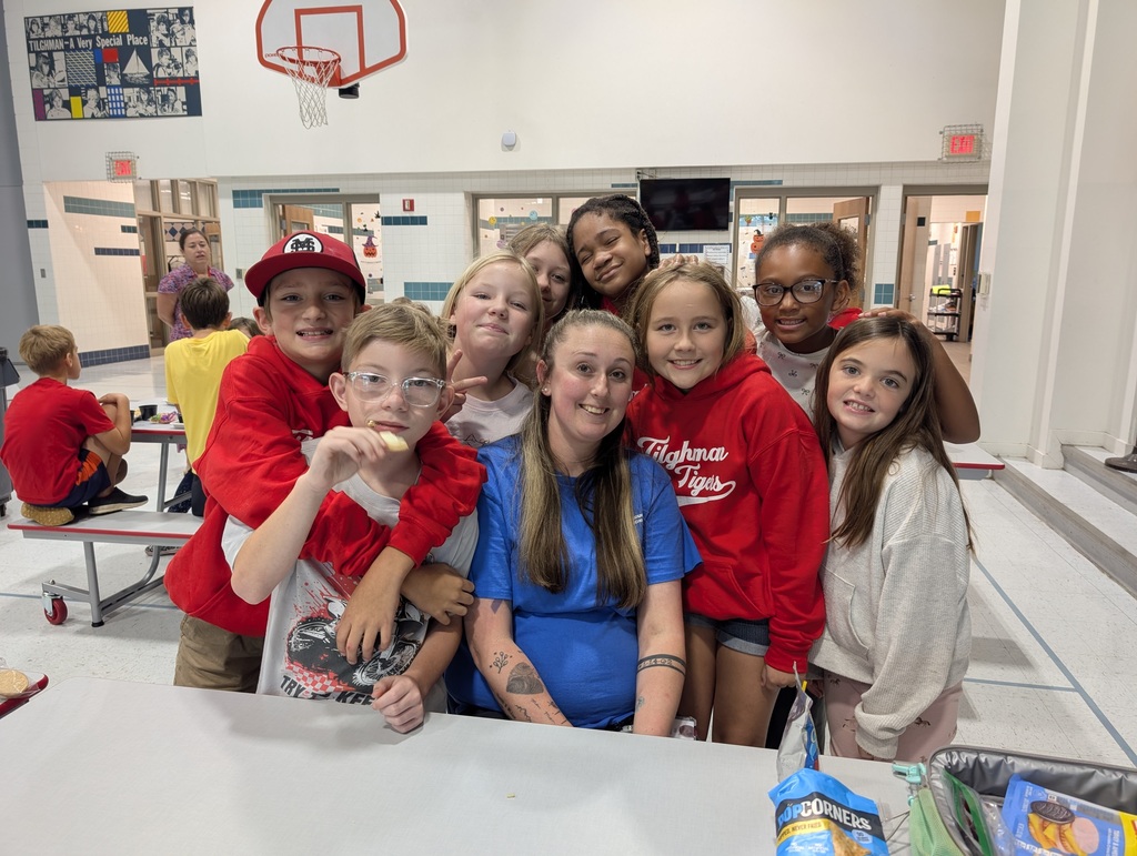 Custodian surrounded by smiling students