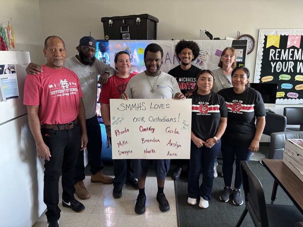 custodians posing with a sign that says "SMMHS loves our custodians!"