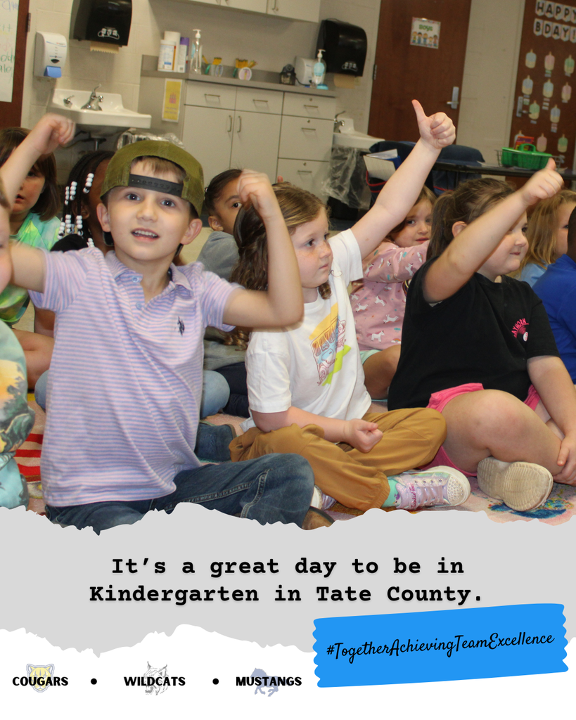 Kindergarteners giving a thumbs up at SES.