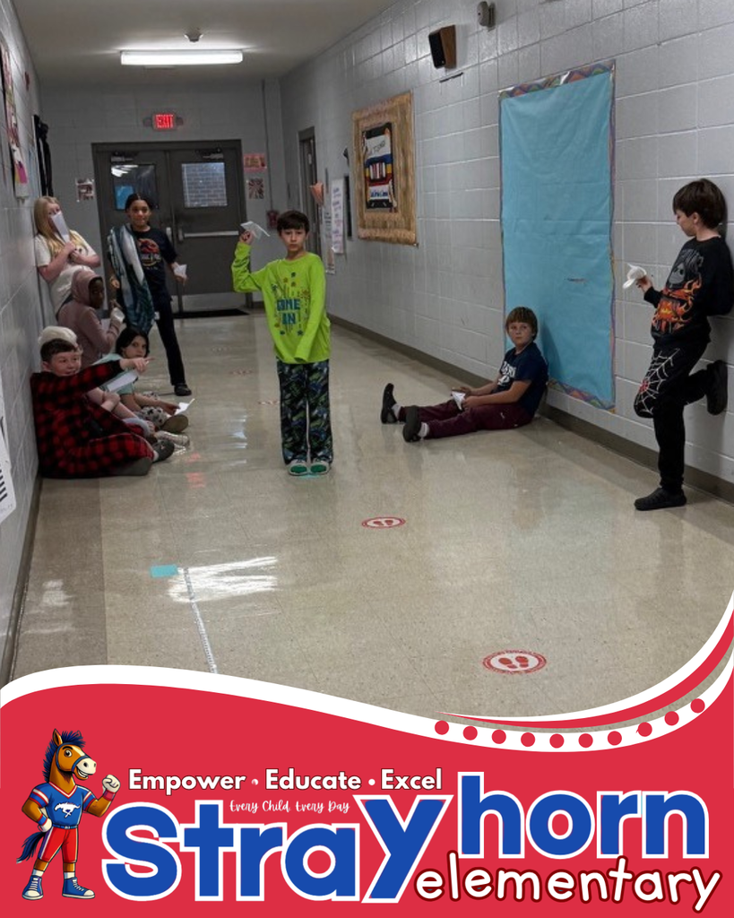 students in hallway with paper airplanes
