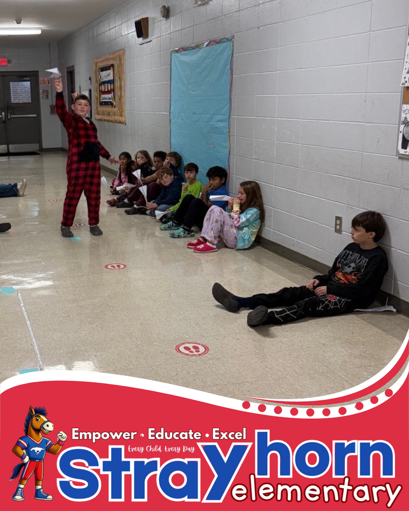 students in hallway with paper airplanes