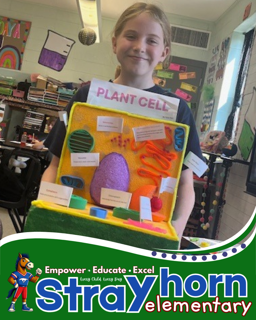 student smiling holding a 3D plant cell