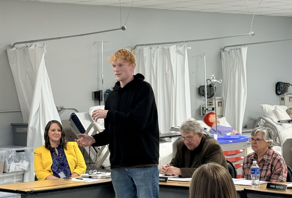 students being recognized at the board meeting