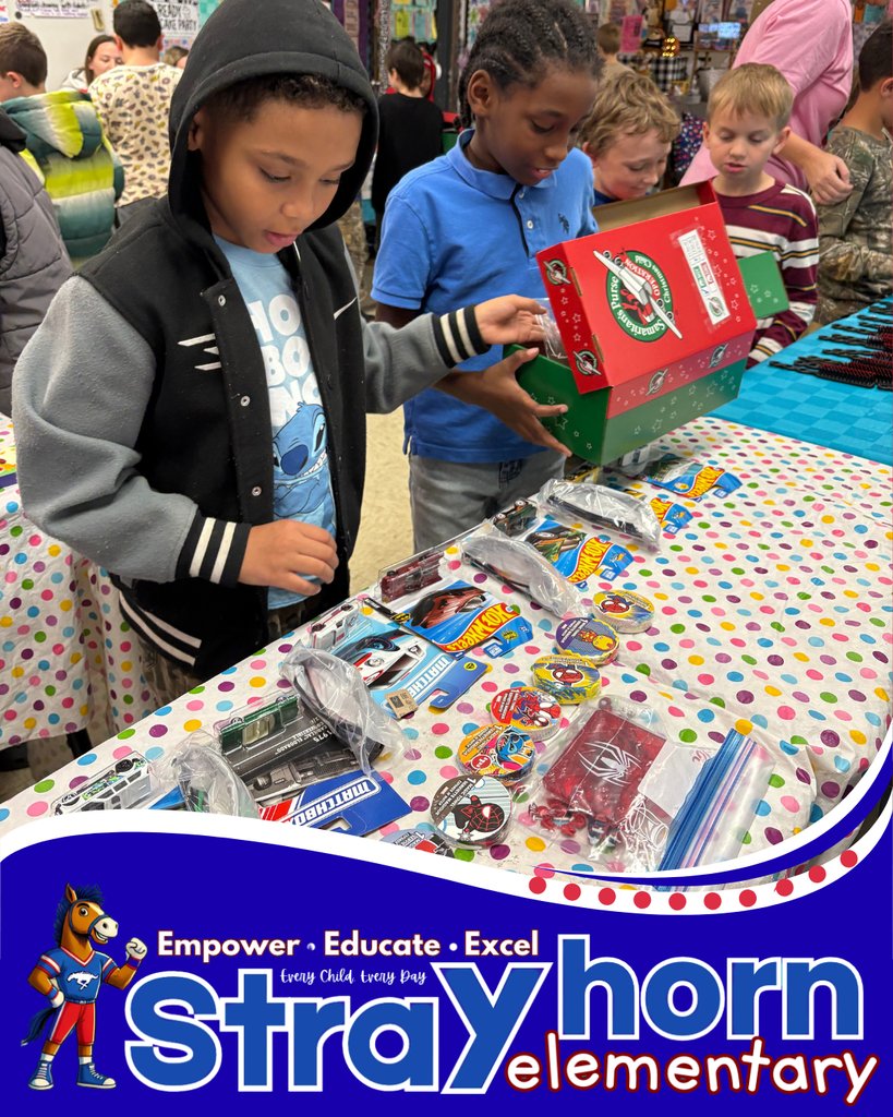 2 boys choosing items for shoebox from items on table