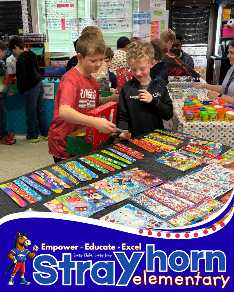 2 boys choosing items for shoebox from items on table