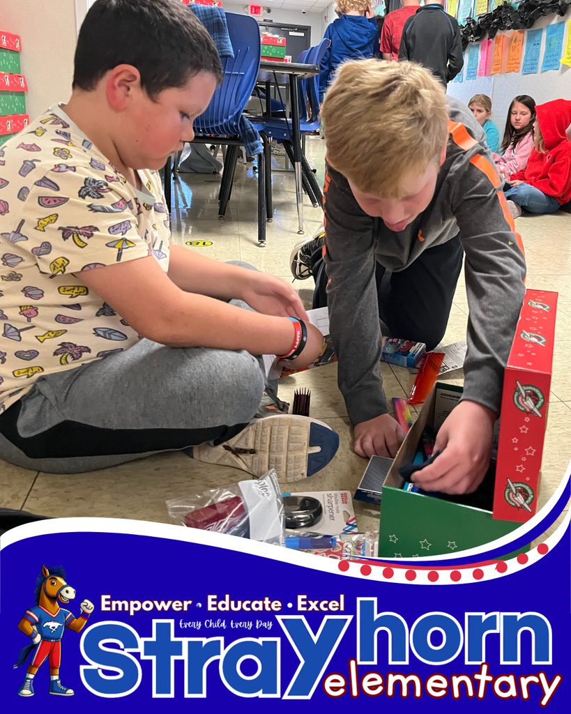 2 boys packing items into shoebox