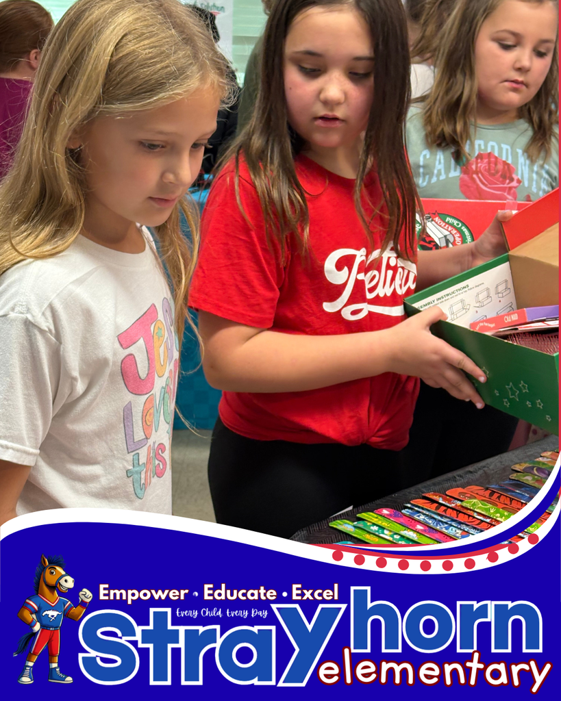2 girls choosing items for shoebox from items on table