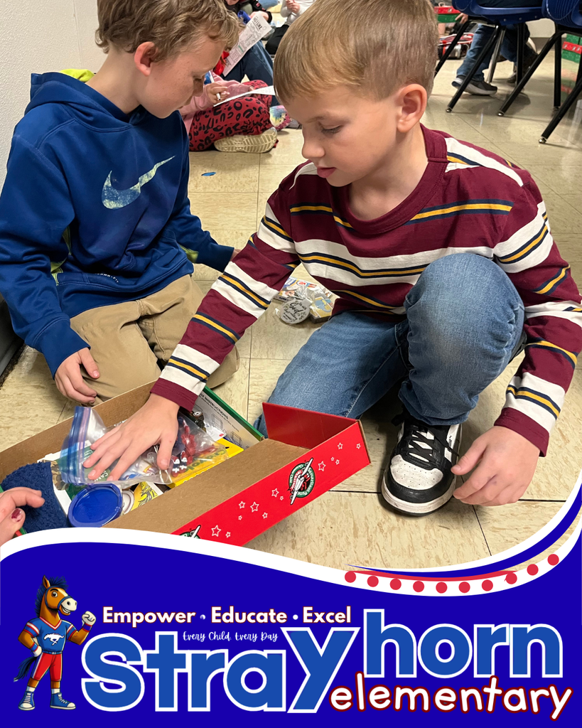 2 boys packing items into shoebox