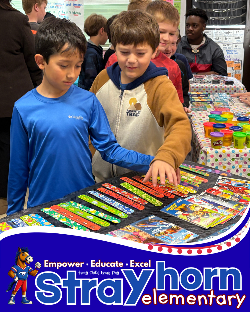 2 boys choosing items for shoebox from items on table