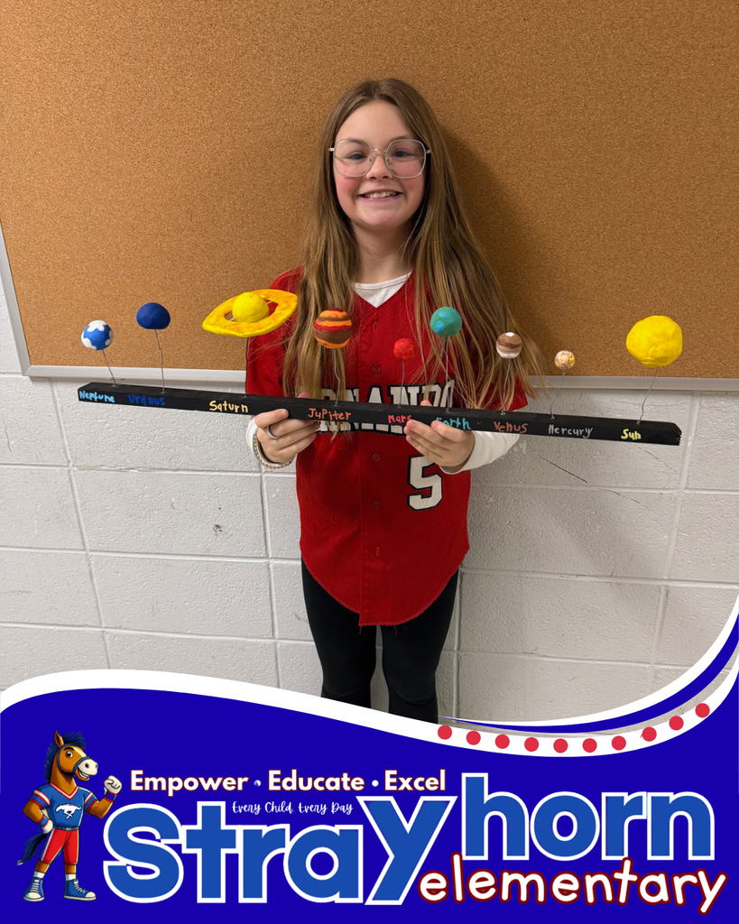 student smiling holding a 3D model of the solar system