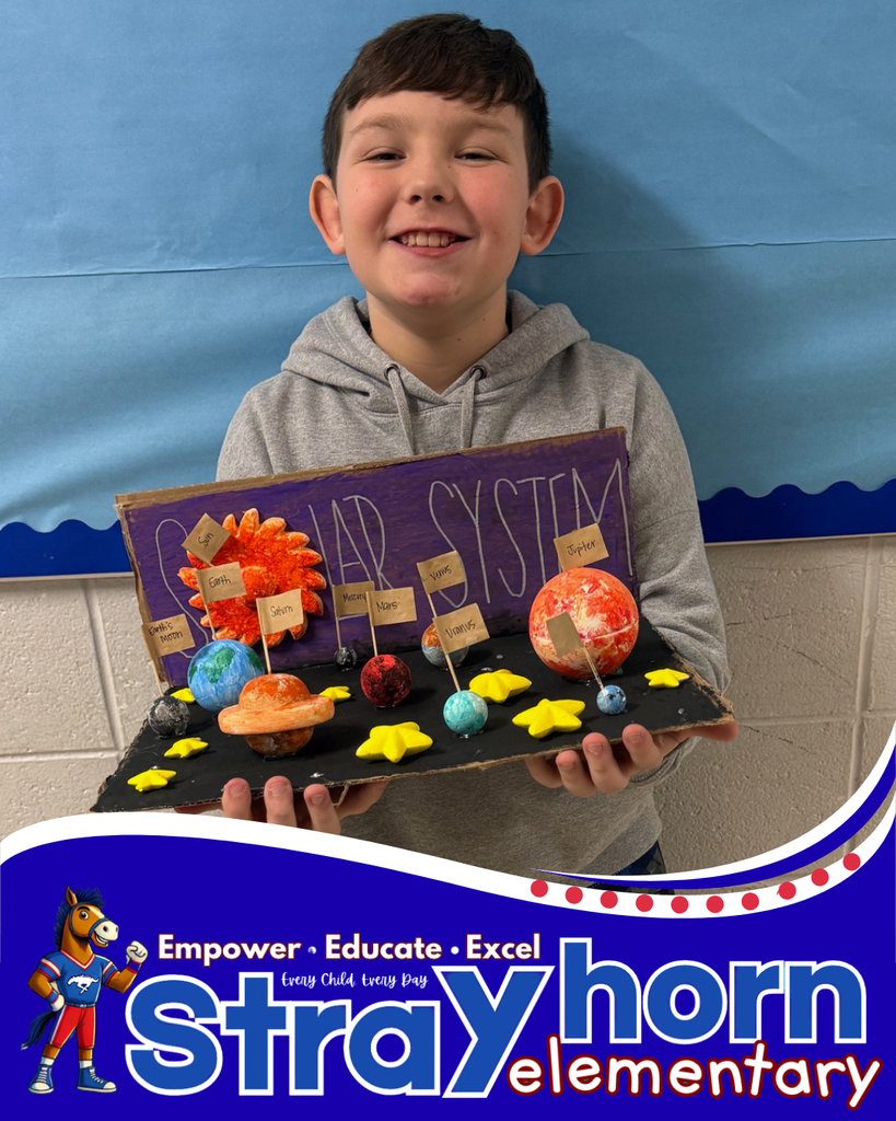 student smiling holding a 3D model of the solar system