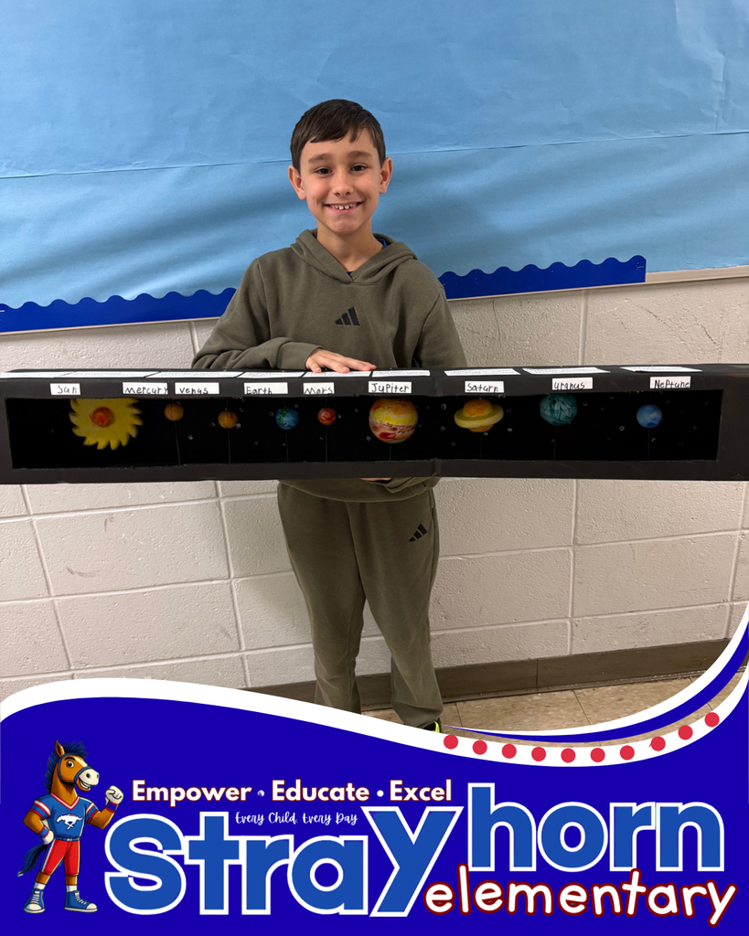 student smiling holding a 3D model of the solar system