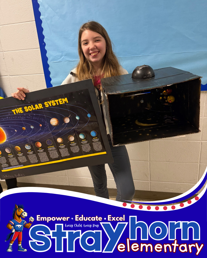 student smiling holding a 3D model of the solar system