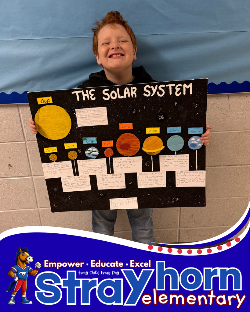 student smiling holding a 3D model of the solar system
