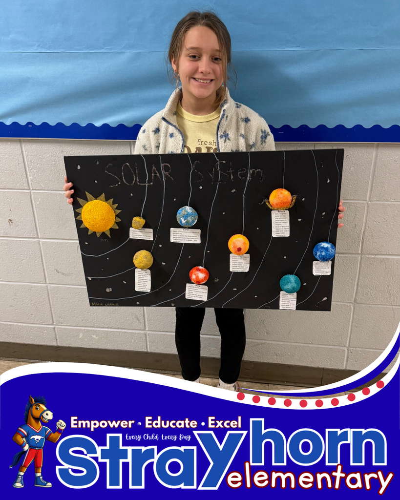 student smiling holding a 3D model of the solar system