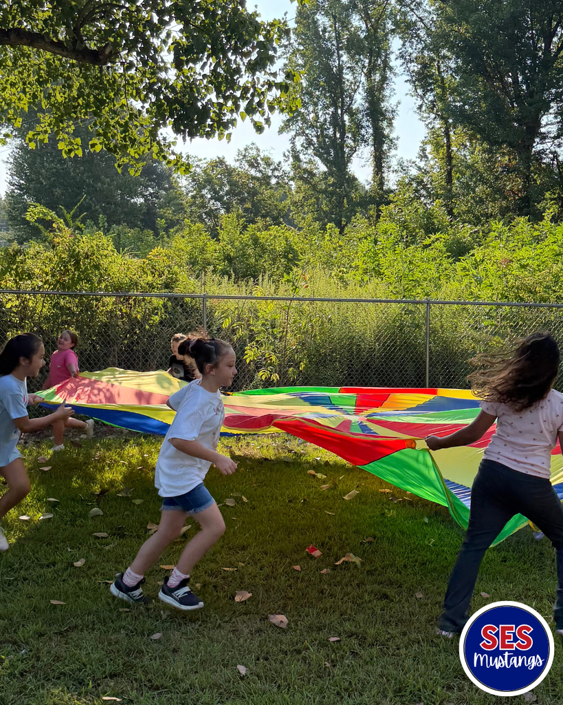 students playing with parachute
