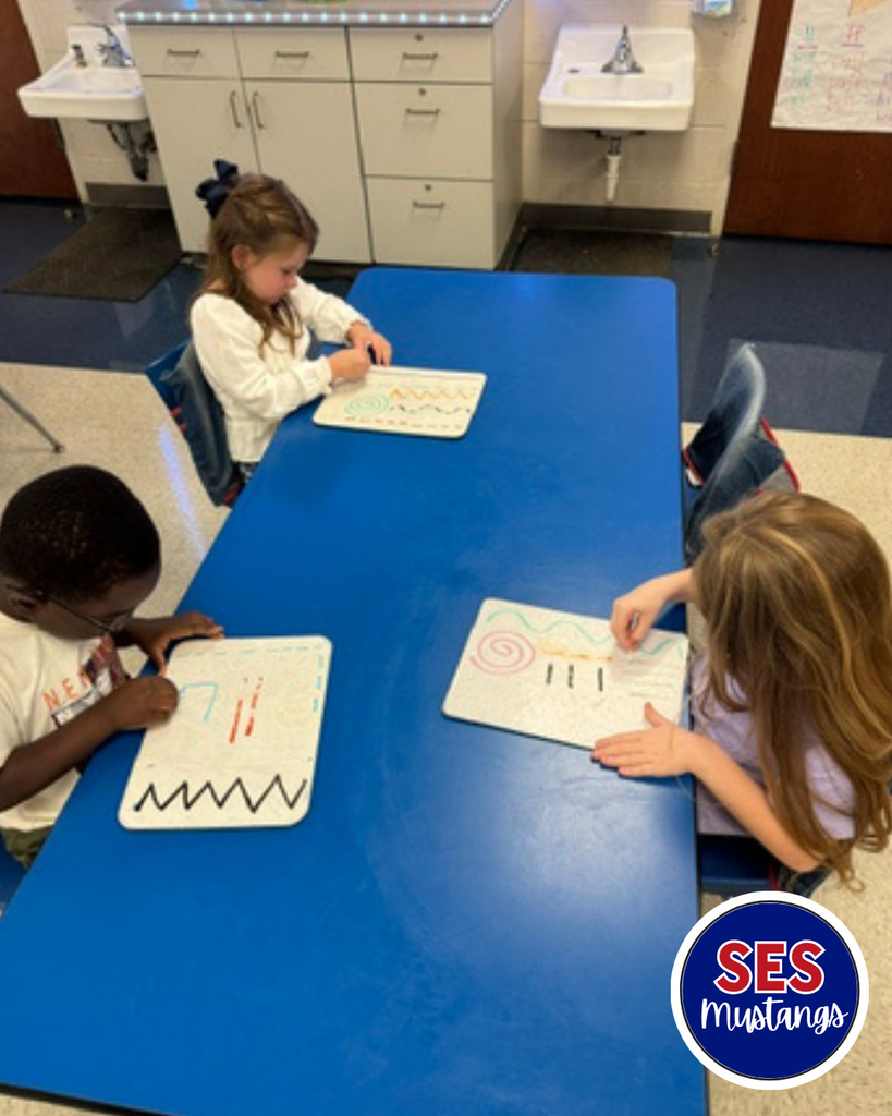 Child with q-tip erasing lines on a whiteboard.