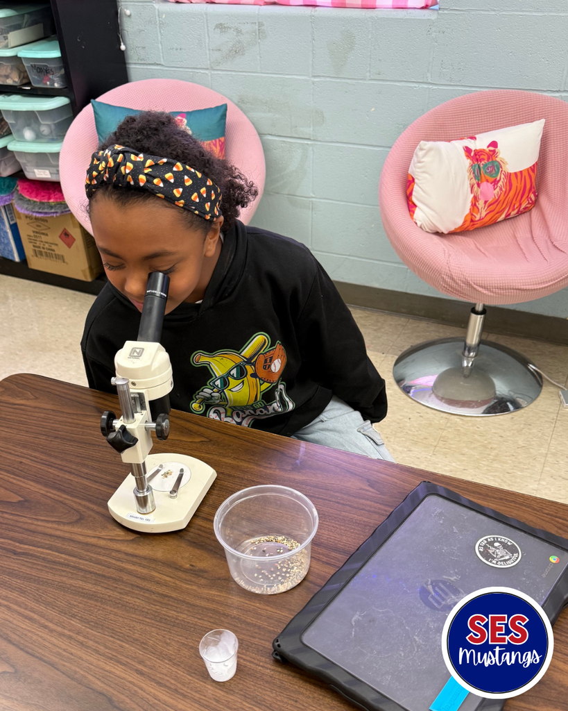 student looking in microscope