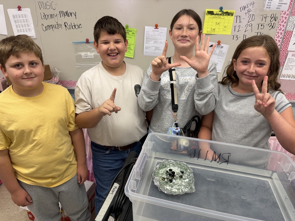 students with aluminum foil boats and water