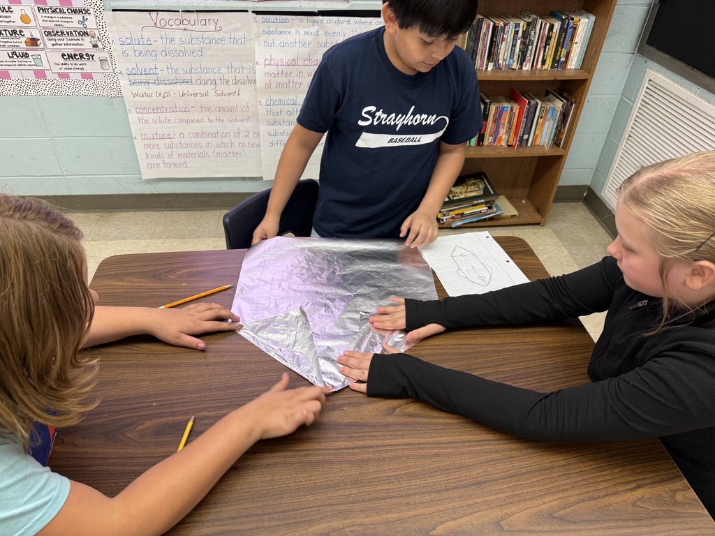 students with aluminum foil boats