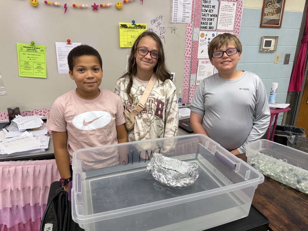 students with aluminum foil boats and water