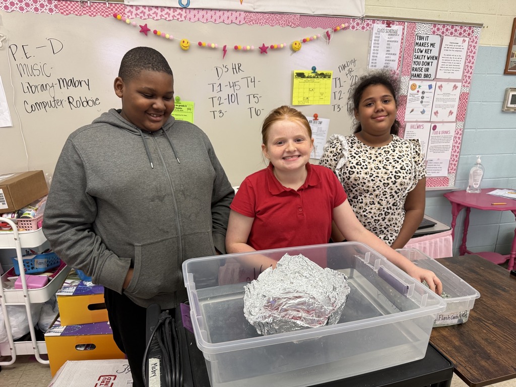 students with aluminum foil boats and water