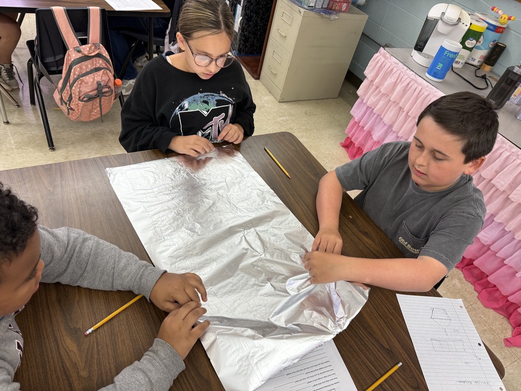 students with aluminum foil boats and water