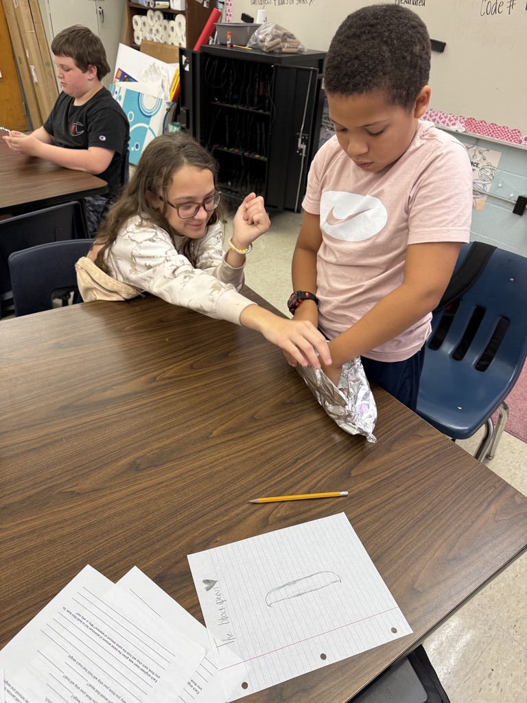 students with aluminum foil boats