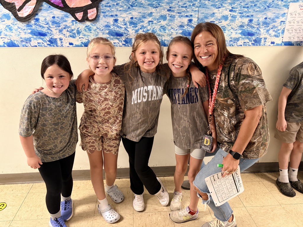 people smiling at the camera wearing camo